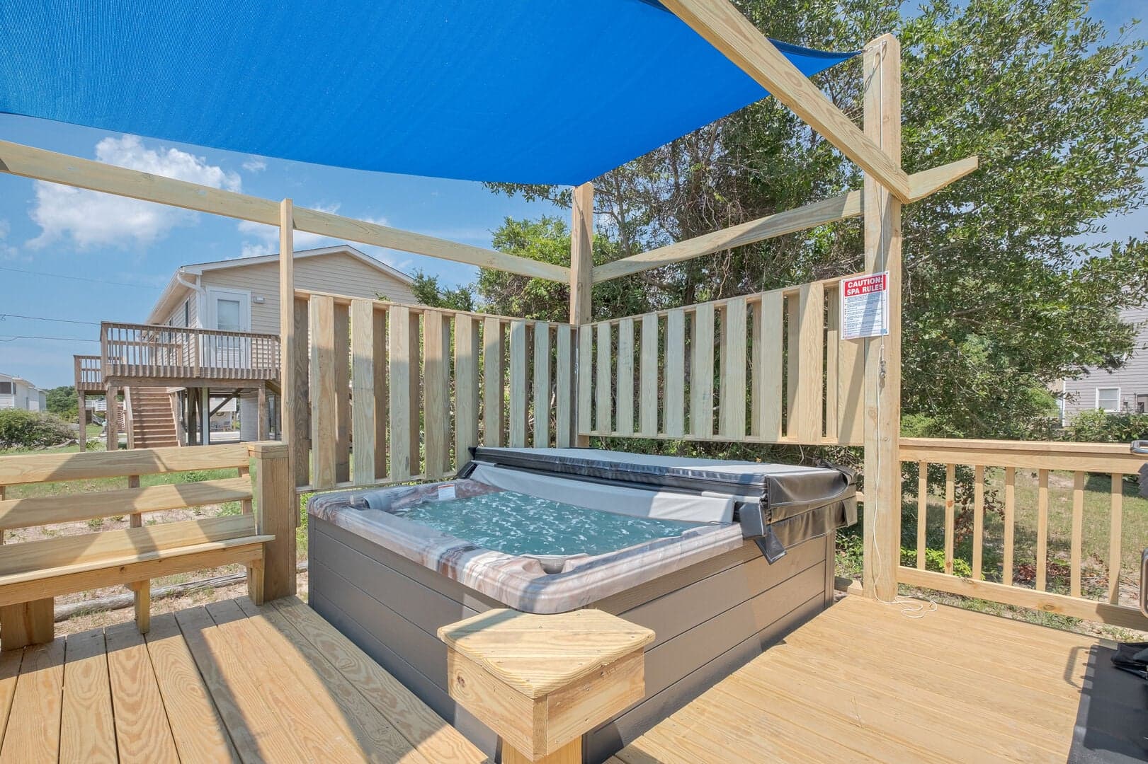 Private hot tub on the shaded deck at Wright by the Beach